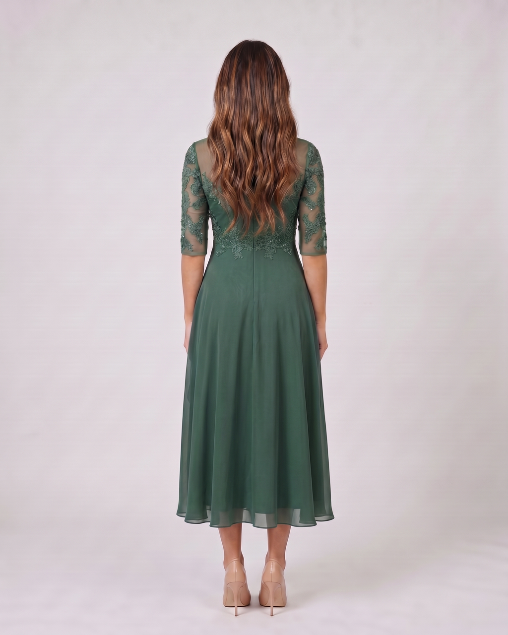 Back view of green lace 3/4 sleeve round neck midi dress showing solid back with lace overlay on upper bodice