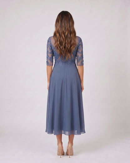 Back view of blue lace 3/4 sleeve round neck midi dress showing solid back with lace overlay on upper bodice