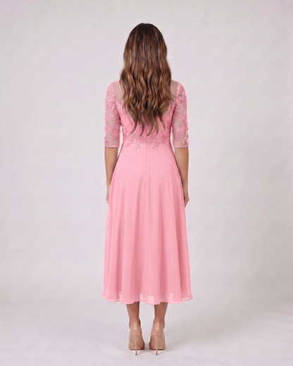 Back view of pink lace 3/4 sleeve round neck midi dress showing solid back with lace overlay on upper bodice