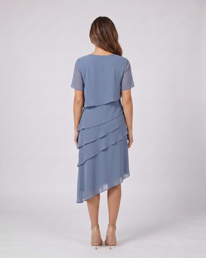 Back view of blue layered ruffled flutter sleeve midi dress showing solid back