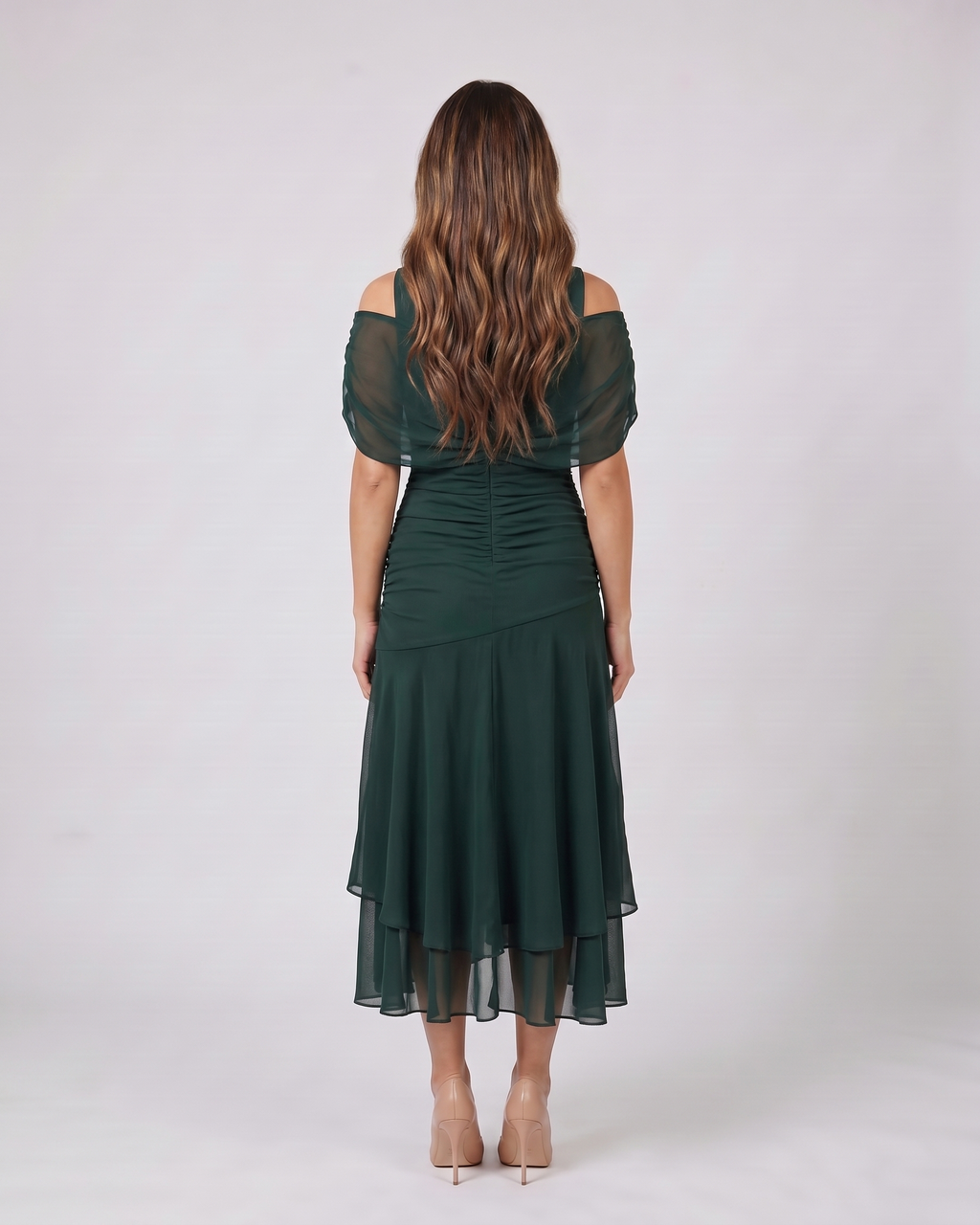 Back view of green off shoulder draped midi dress showing solid back with ruched waist detail