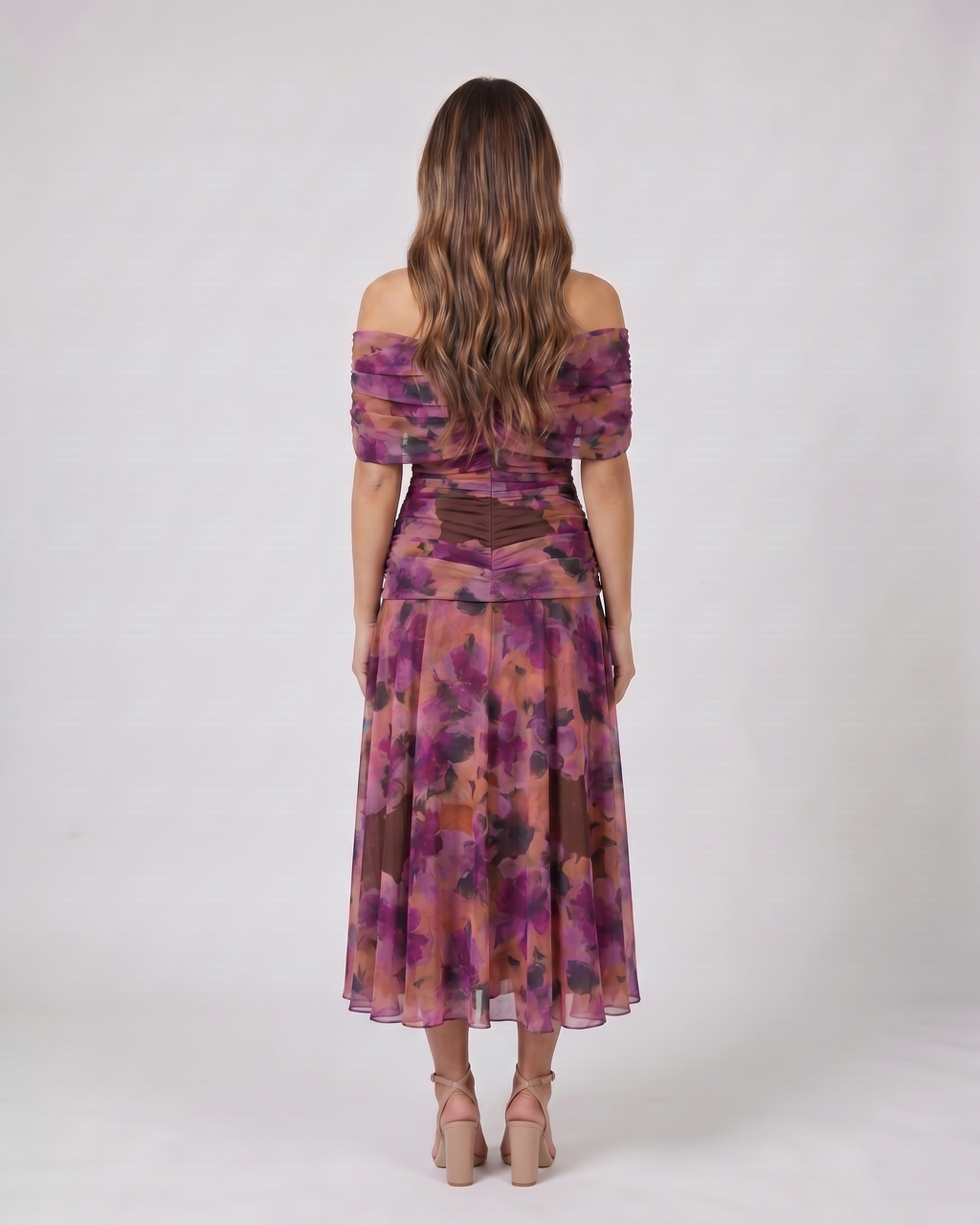 Back view of purple off shoulder ruched midi dress showing solid back with draped and ruched details