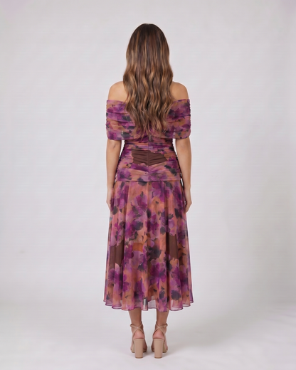Back view of purple off shoulder ruched midi dress showing solid back with draped and ruched details