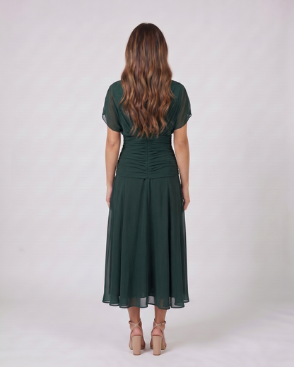 Back view of green off shoulder ruched midi dress showing solid back with draped and ruched details