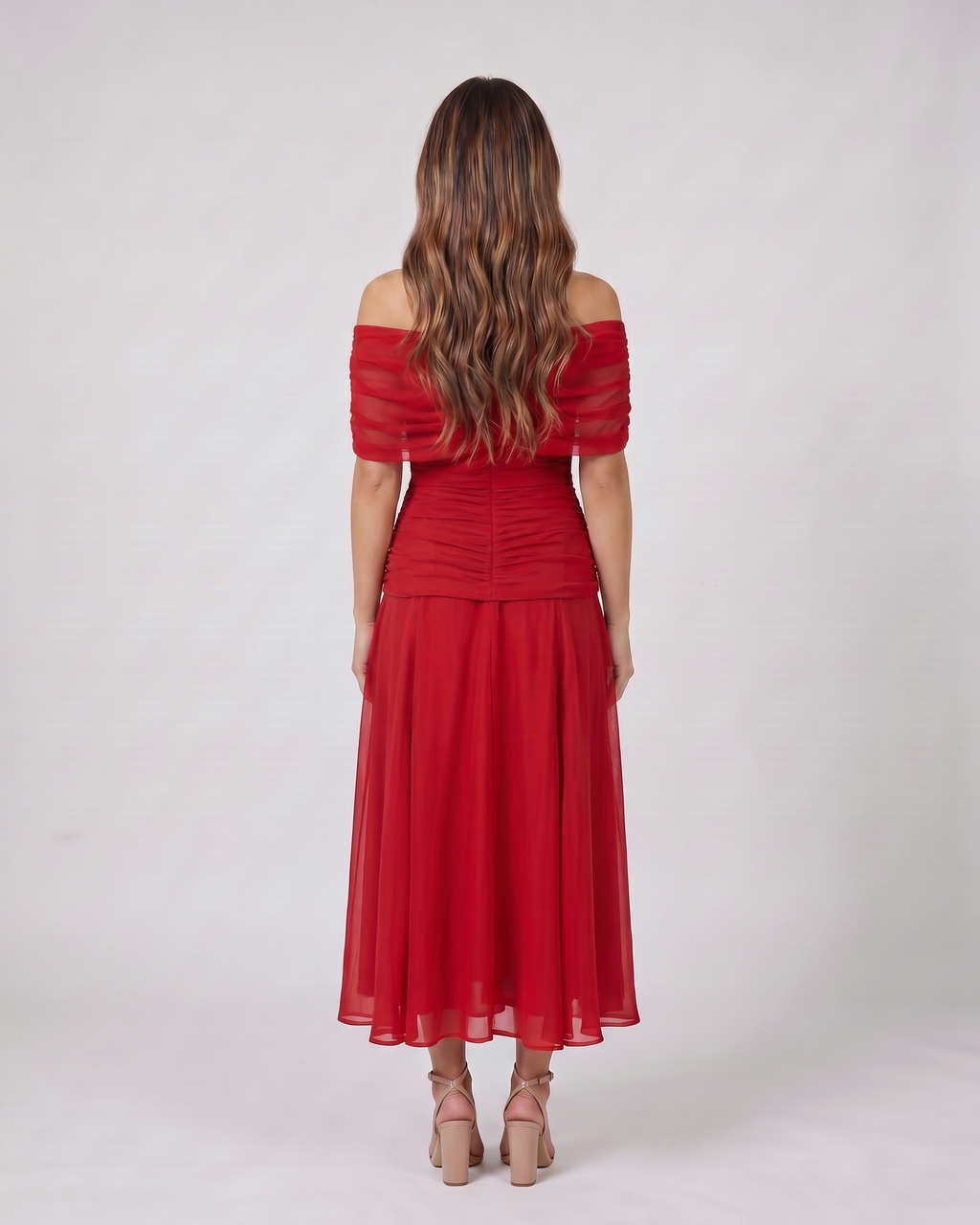 Back view of red off shoulder ruched midi dress showing solid back with draped and ruched details