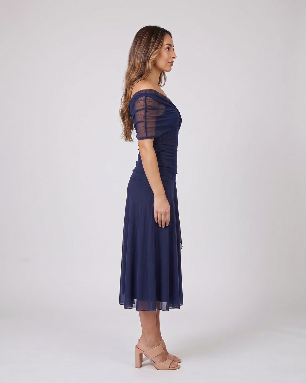 Side view of blue off shoulder ruched midi dress