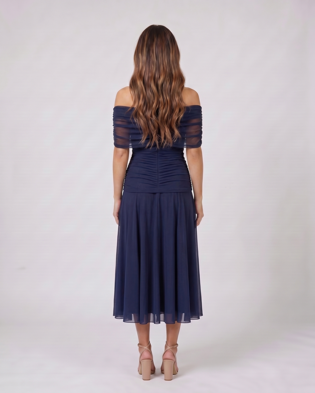 Back view of blue off shoulder ruched midi dress showing solid back with draped and ruched details