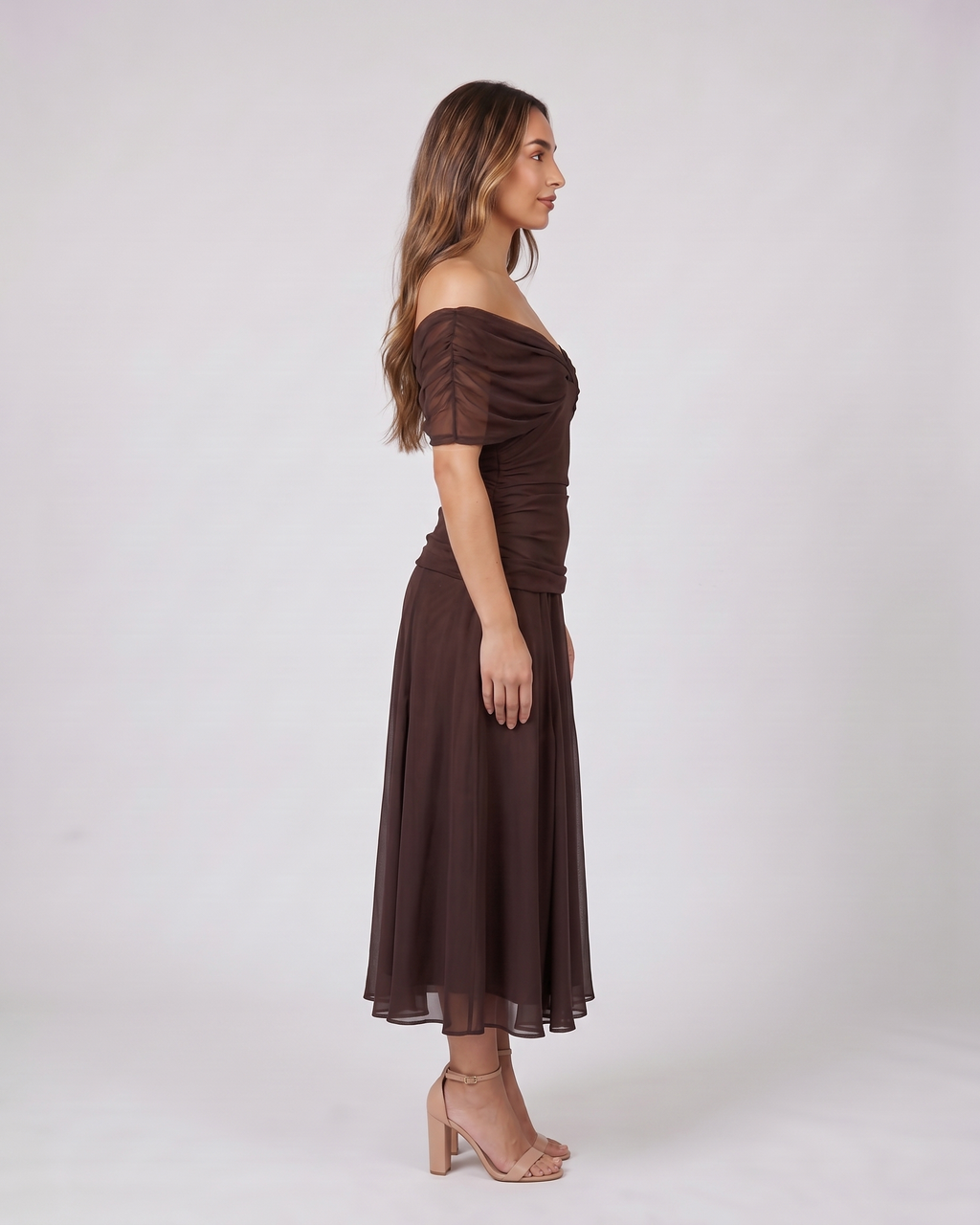 Side view of brown off shoulder ruched midi dress