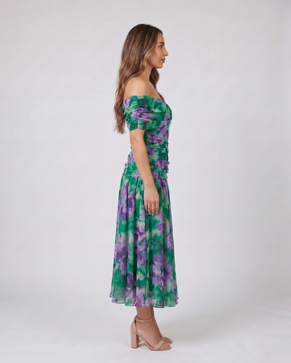 Side view of green and purple off shoulder ruched midi dress