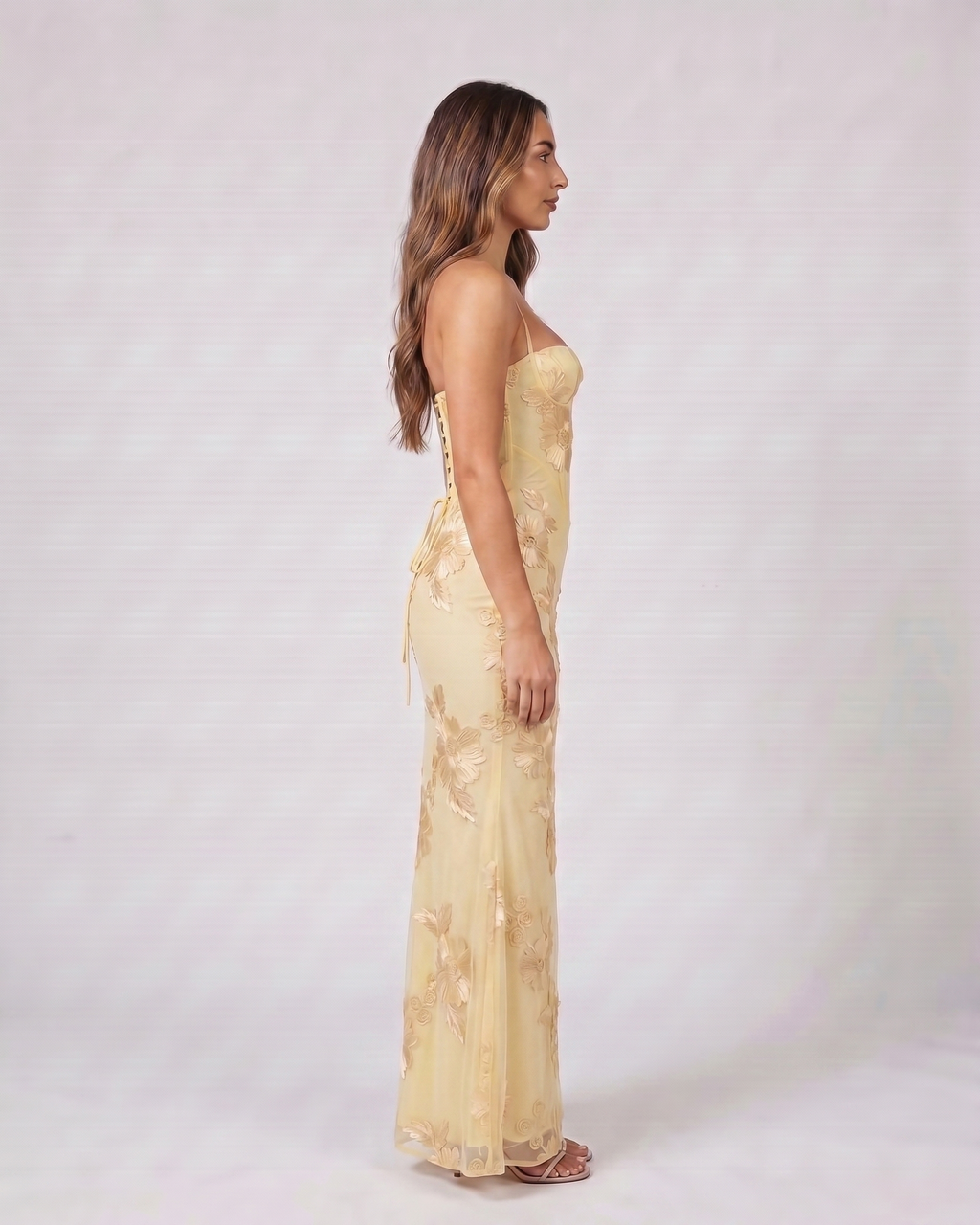 Side view of yellow prom sweetheart floral appliqué maxi dress