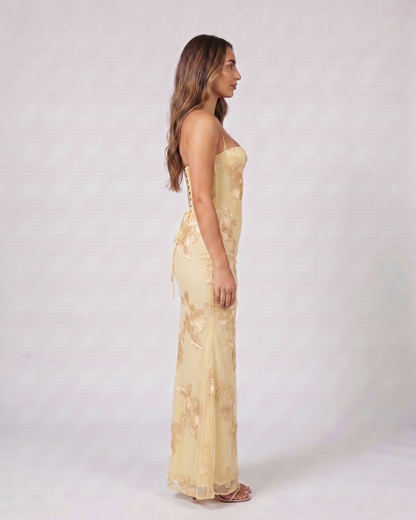 Side view of yellow prom sweetheart floral appliqué maxi dress