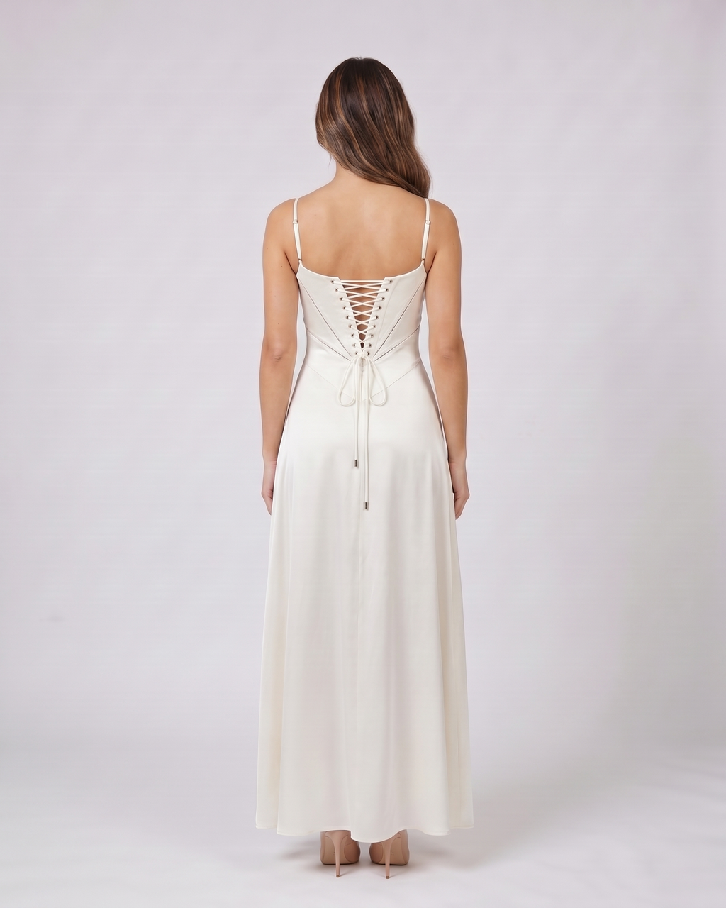 Back view of ivory satin square neck seamed maxi dress showing lace-up corset back with metallic grommets