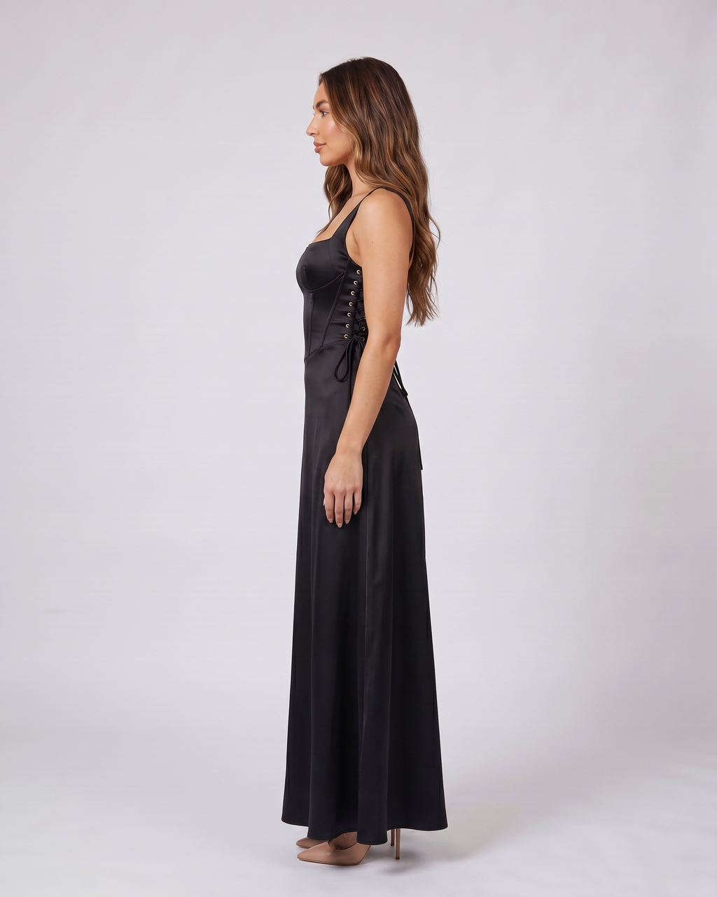 Side view of black satin square neck seamed maxi dress