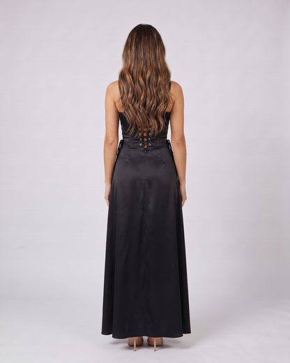 Back view of black satin square neck seamed maxi dress showing lace-up corset back with metallic grommets