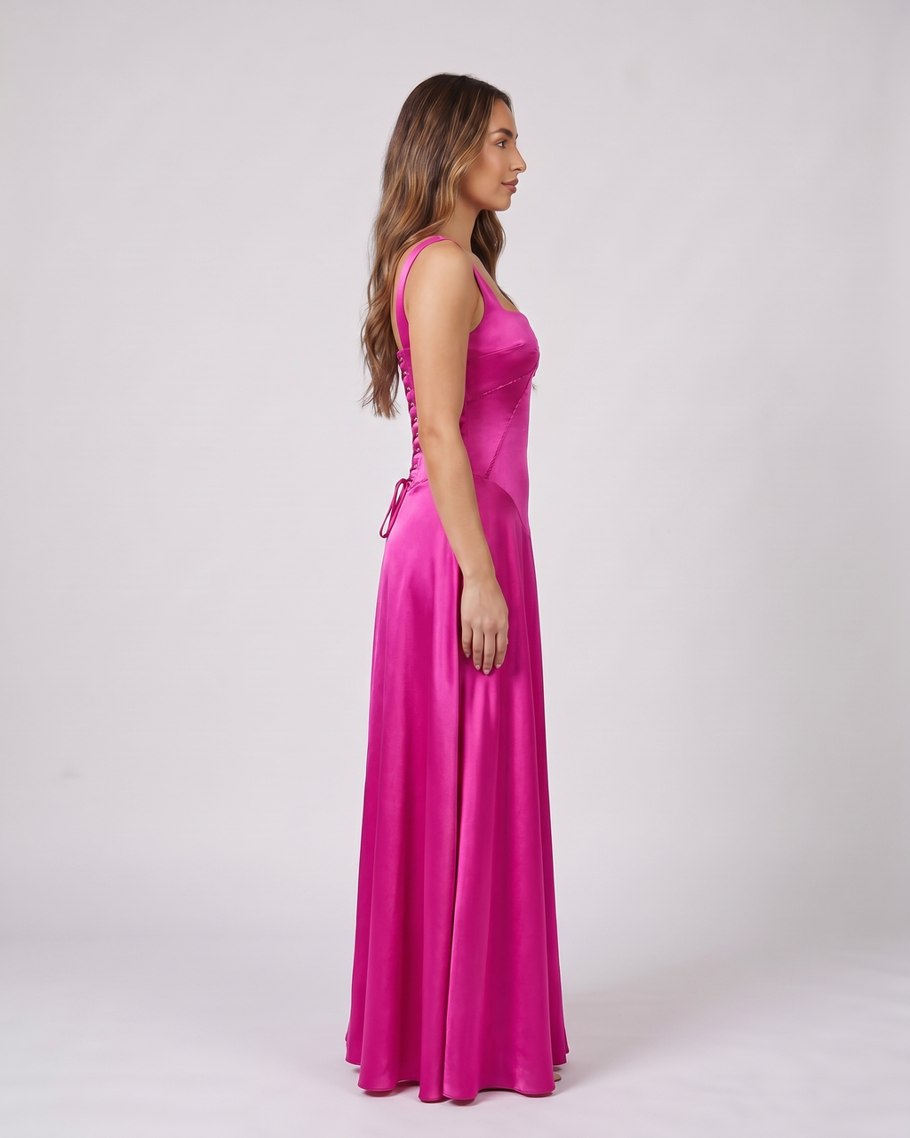 Side view of pink satin square neck seamed maxi dress