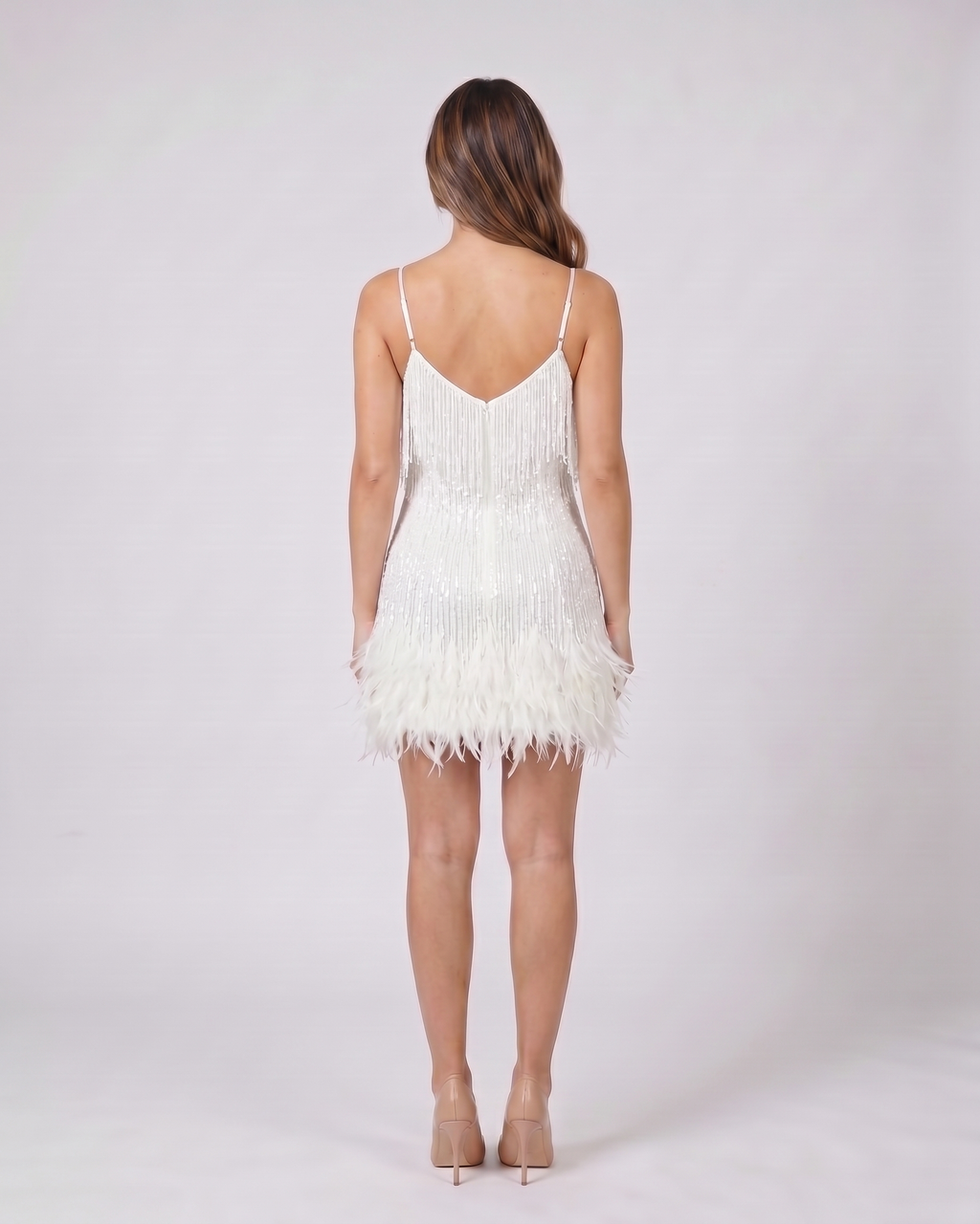 Back view of white sequin v neck fringe mini dress showing v-back neckline with invisible zipper closure