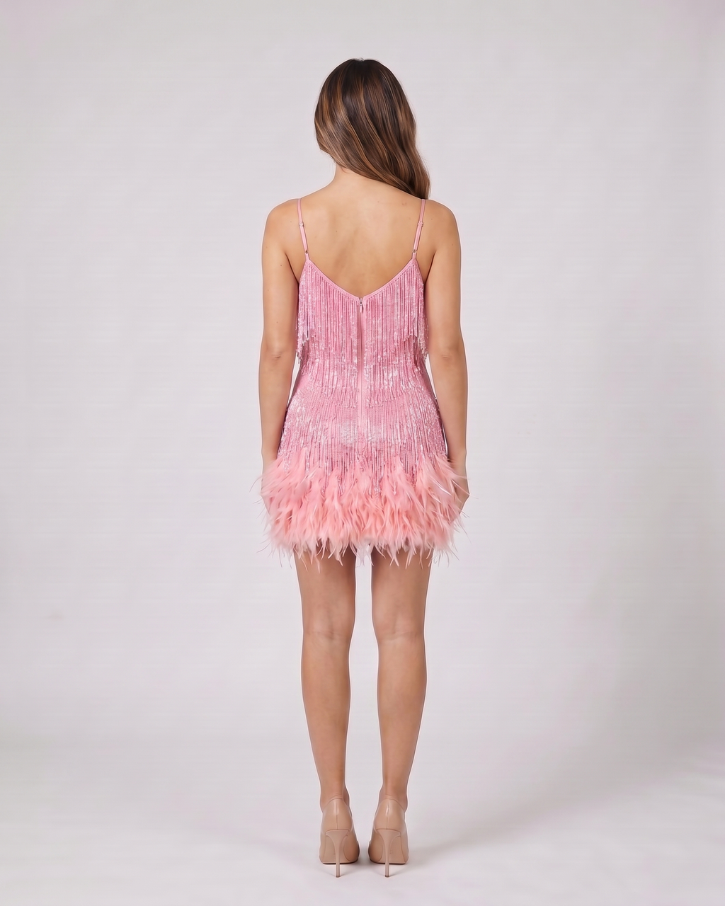 Back view of pink sequin v neck fringe mini dress showing v-back neckline with invisible zipper closure
