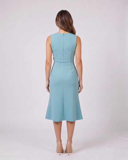 Back view of light blue sleeveless asymmetric draped midi dress showing solid back with center back zipper closure