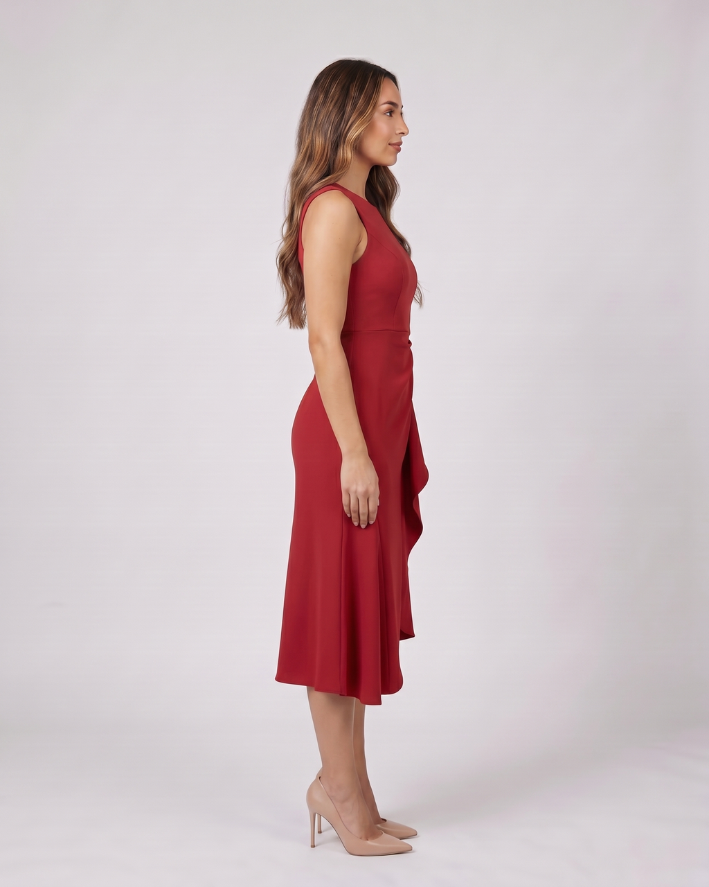 Side view of red sleeveless asymmetric draped midi dress