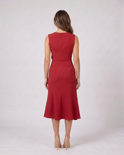 Back view of red sleeveless asymmetric draped midi dress showing solid back with center back zipper closure