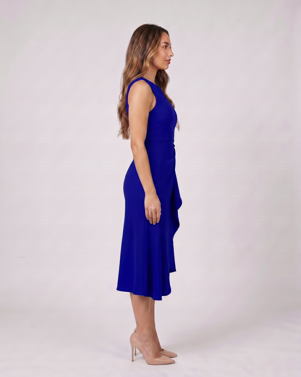 Side view of navy blue sleeveless asymmetric draped midi dress