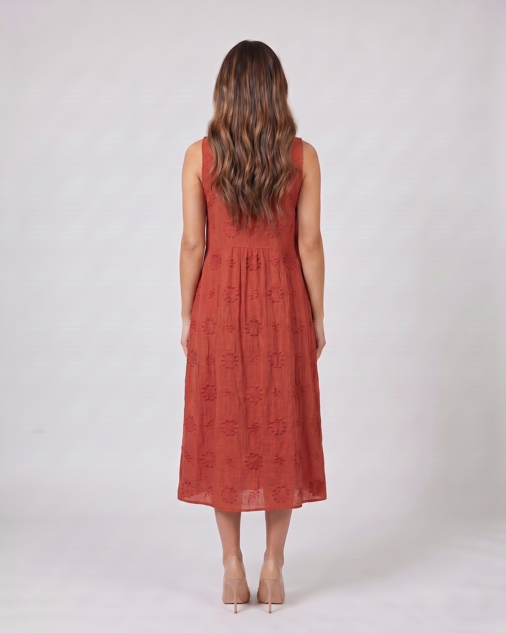 Back view of red sleeveless round neck embroidered midi dress showing solid back