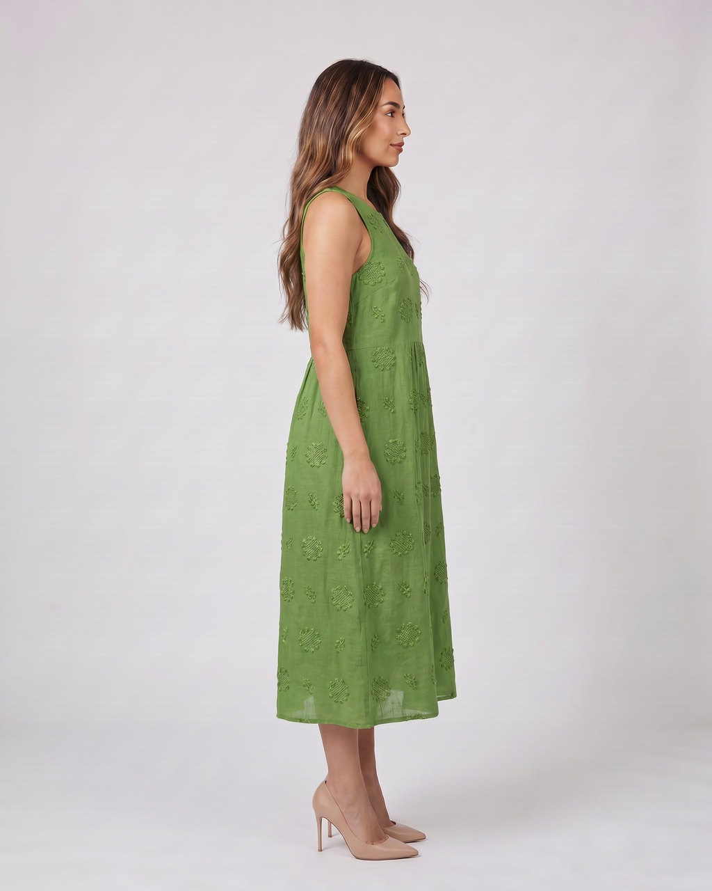 Side view of green sleeveless round neck embroidered midi dress