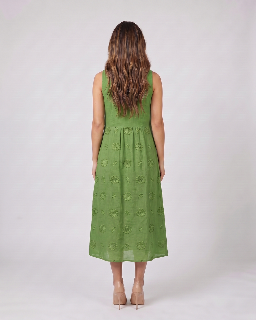 Back view of green sleeveless round neck embroidered midi dress showing solid back