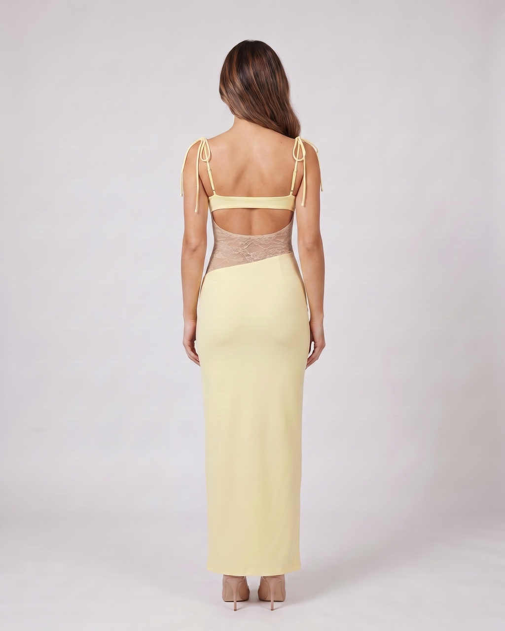 Back view of yellow square neck lace panel maxi dress showing open-panel back with horizontal mid-back strap and integrated lace detail