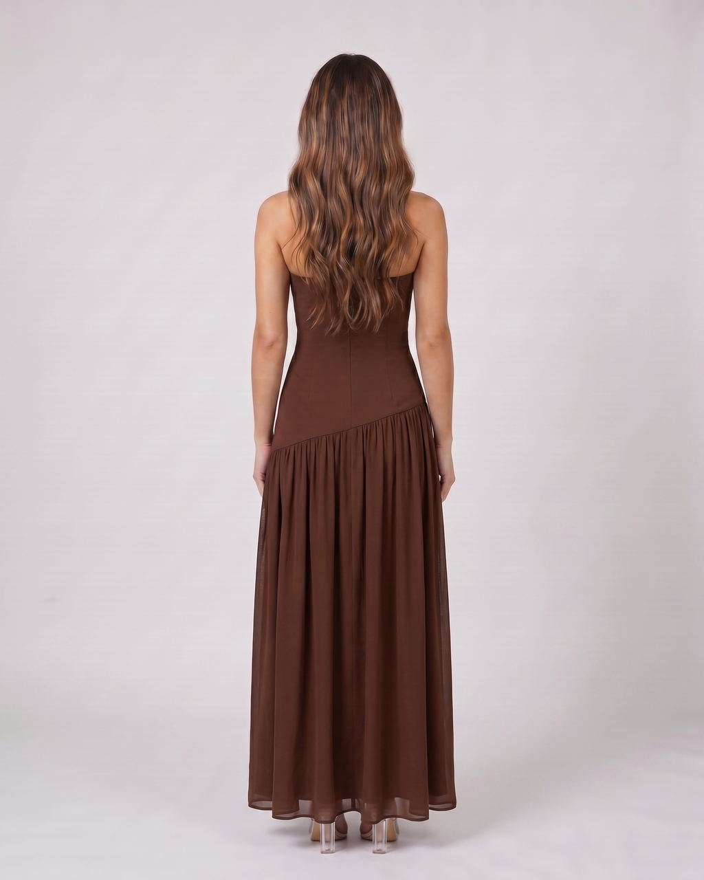 Back view of brown strapless bandeau with front split maxi dress showing solid back with no visible closure details