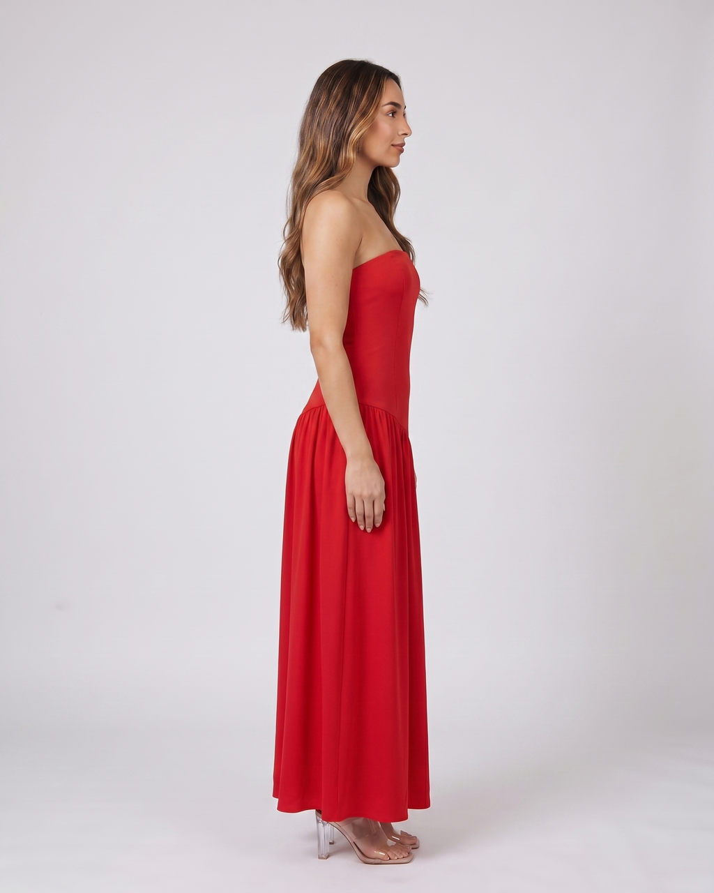 Side view of red strapless bandeau with front split maxi dress