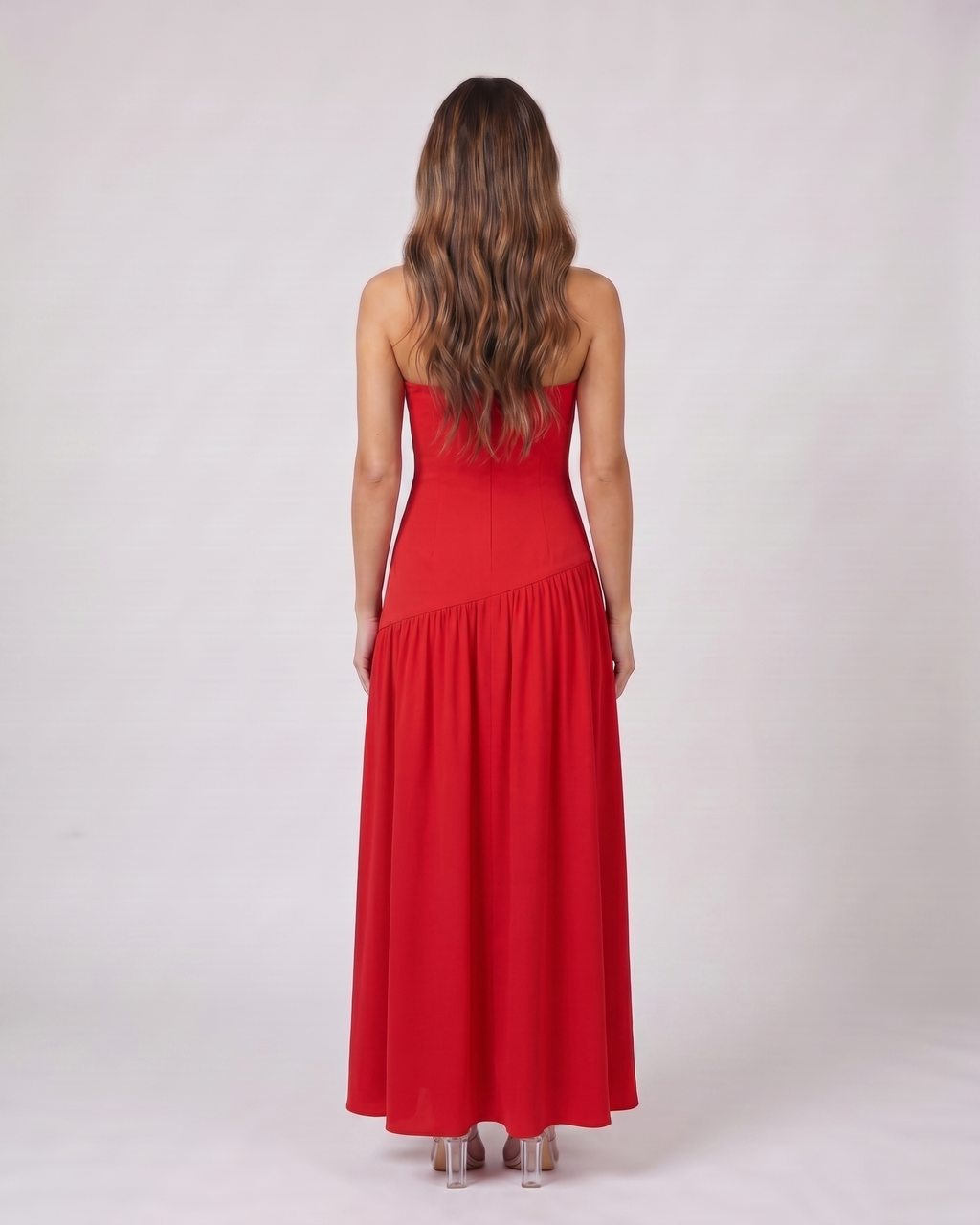 Back view of red strapless bandeau with front split maxi dress showing solid back with no visible closure details