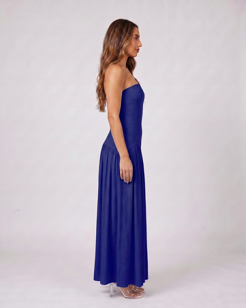 Side view of navy strapless bandeau with front split maxi dress