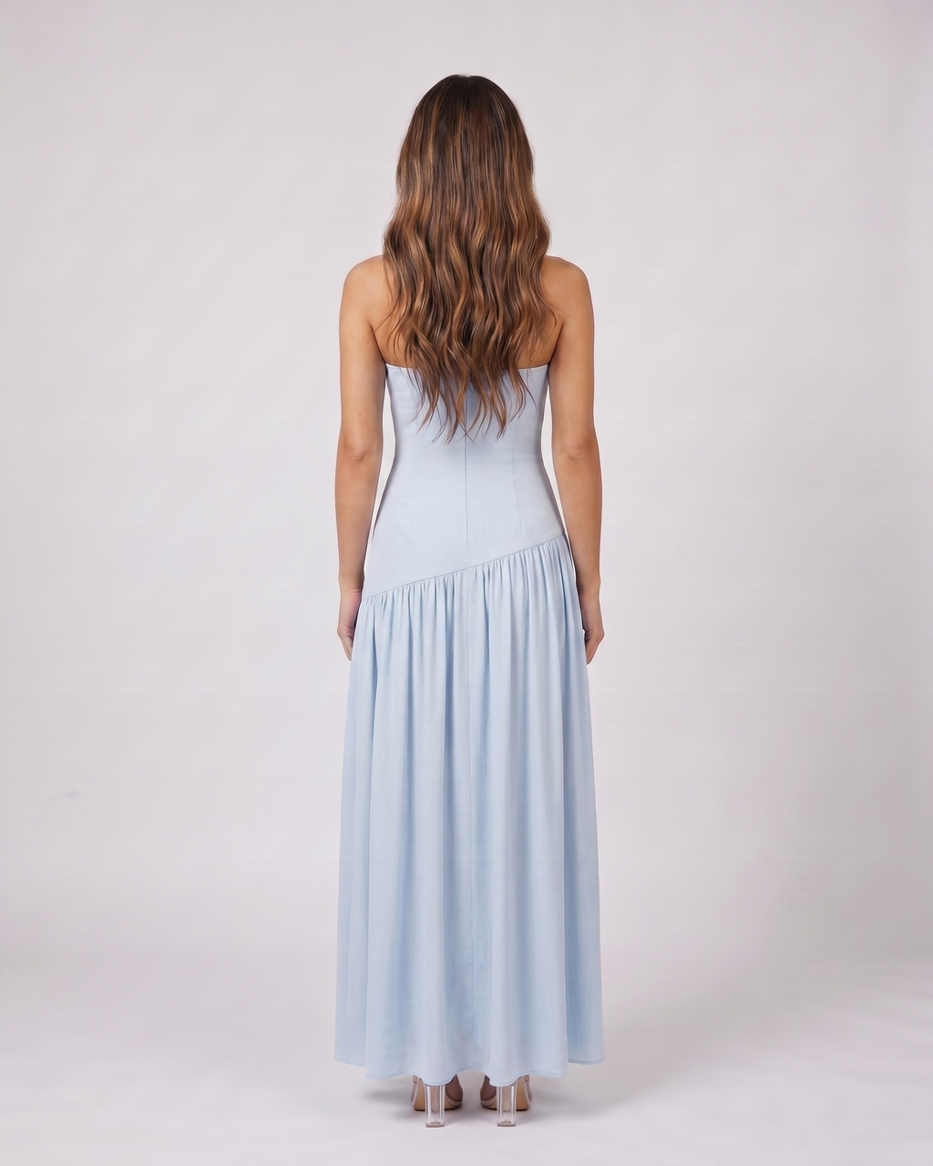 Back view of blue strapless bandeau with front split maxi dress showing solid back with no visible closure details