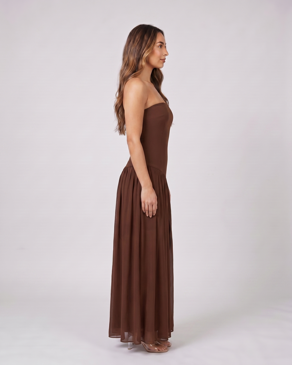 Side view of brown strapless bandeau with front split maxi dress