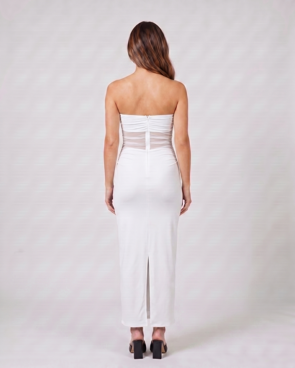 Back view of white strapless bodycon with scarf maxi dress showing solid back with concealed center back zipper and center back slit at hem