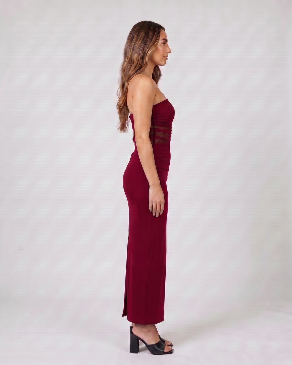 Side view of burgundy strapless bodycon with scarf maxi dress