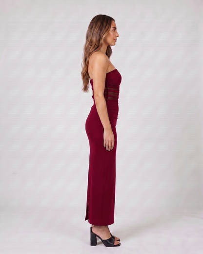 Side view of burgundy strapless bodycon with scarf maxi dress