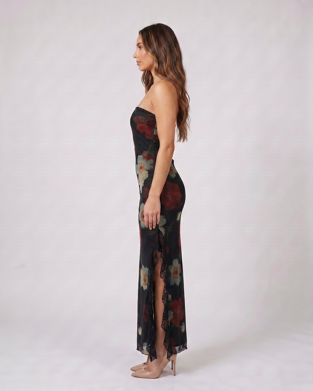 Side view of black strapless floral ruffle slit maxi dress
