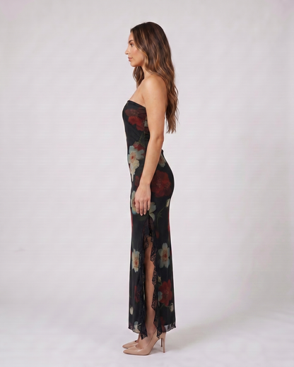 Side view of black strapless floral ruffle slit maxi dress