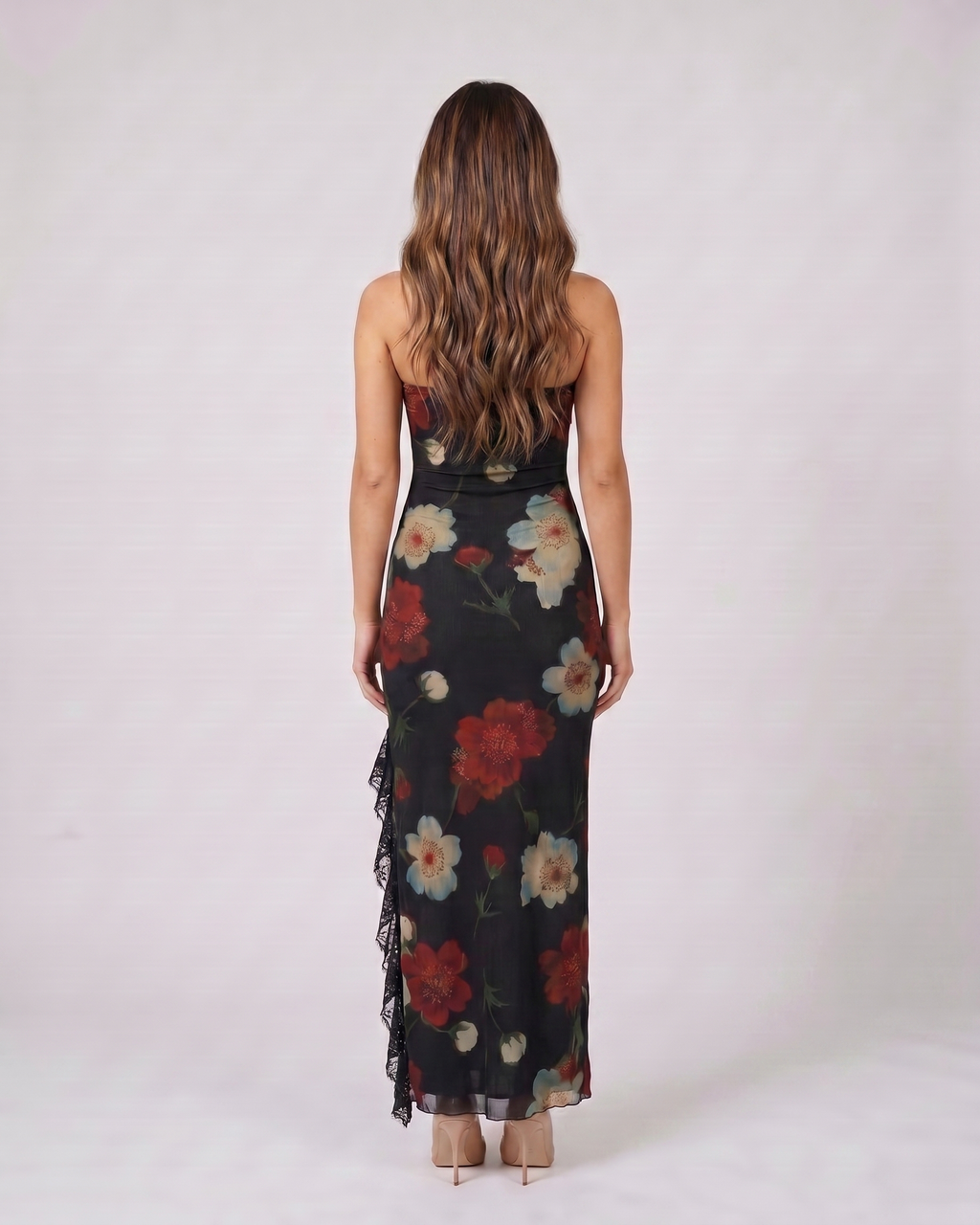 Back view of black strapless floral ruffle slit maxi dress showing solid back