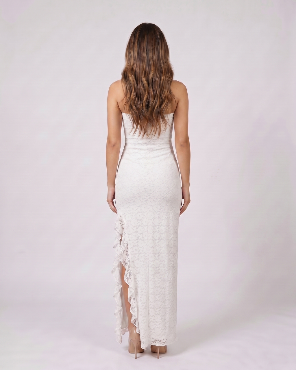 Back view of white strapless floral ruffle slit maxi dress showing solid back