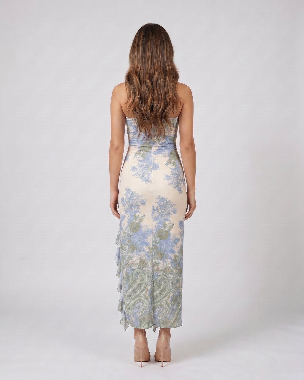 Back view of green strapless floral ruffle slit maxi dress showing solid back