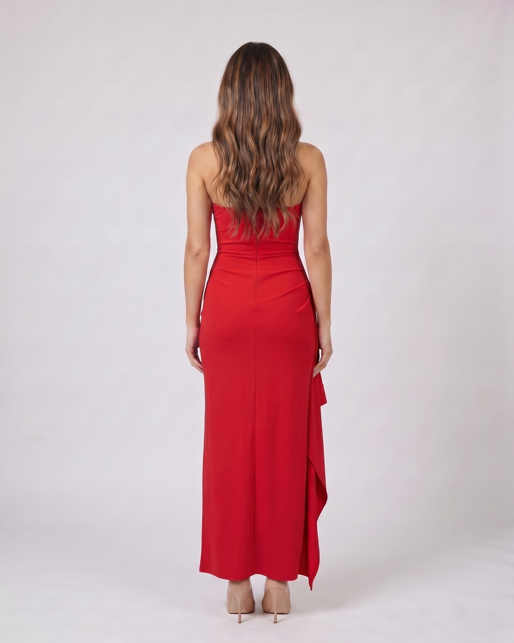 Back view of red strapless ruched thigh split maxi dress showing solid back with center back zipper closure