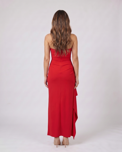 Back view of red strapless ruched thigh split maxi dress showing solid back with center back zipper closure