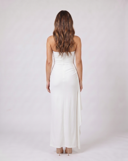 Back view of white strapless ruched thigh split maxi dress showing solid back with center back zipper closure