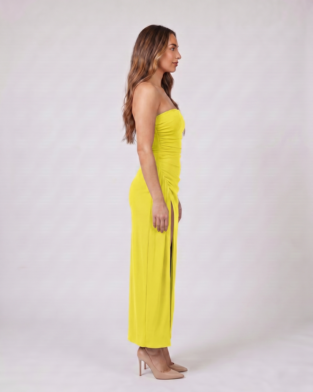 Side view of lemon strapless ruched thigh split maxi dress