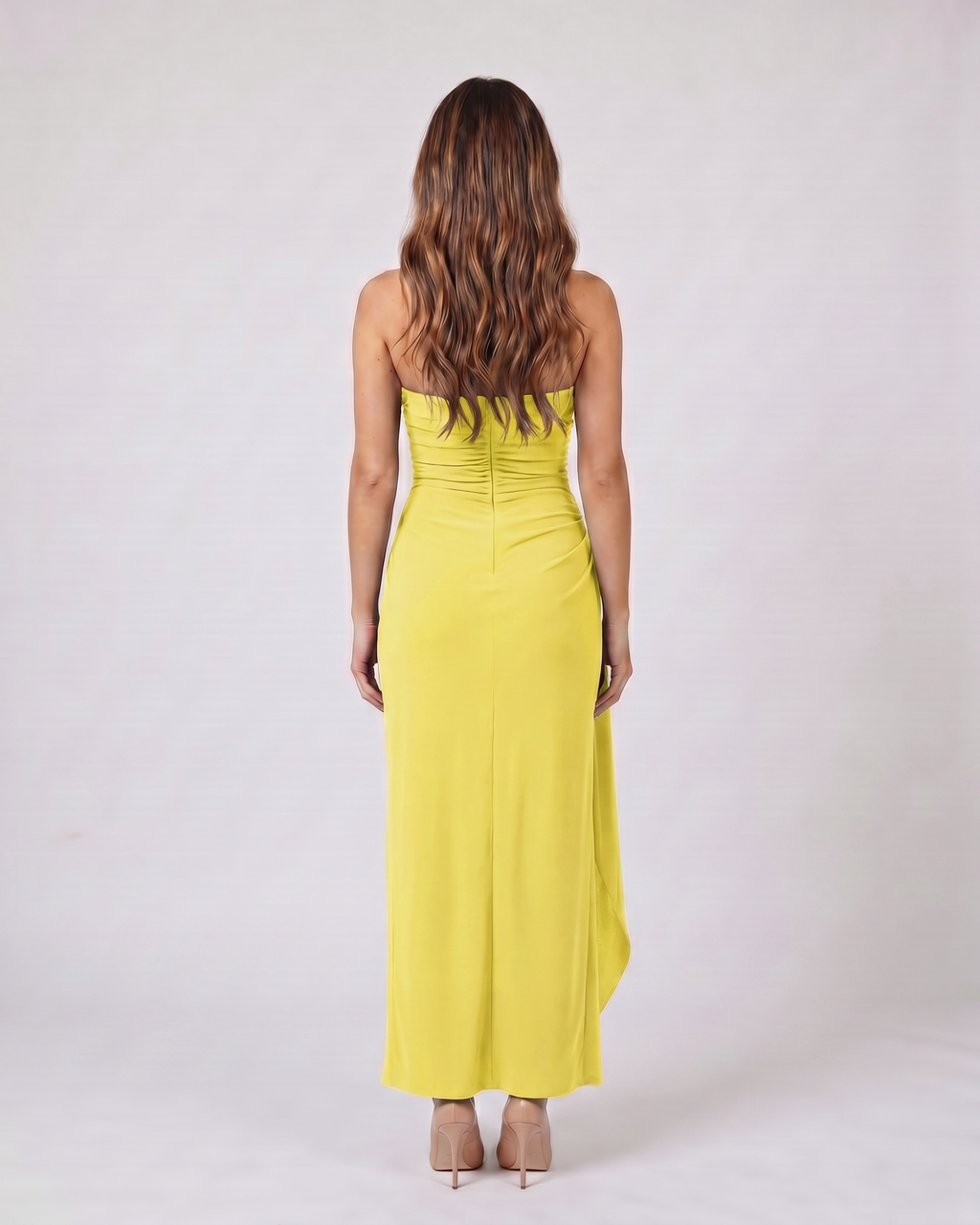 Back view of lemon strapless ruched thigh split maxi dress showing solid back with center back zipper closure