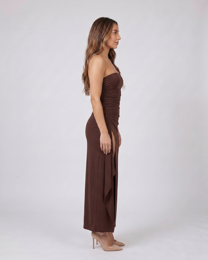 Side view of brown strapless ruched thigh split maxi dress