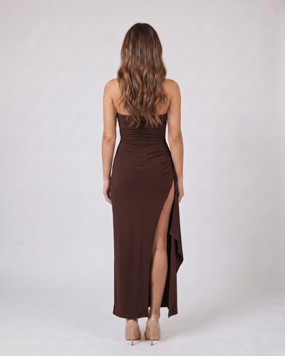 Back view of brown strapless ruched thigh split maxi dress showing solid back with center back zipper closure